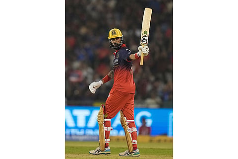 Royal Challengers Bengaluru's Krunal Pandya celebrates his fifty runs during the Indian Premier League cricket match between Royal Challengers Bengaluru and Mumbai Indians in Raipur, India.
