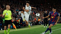 AP Photo : Real Madrid's Gonzalo Garcia fights for the ball against Barcelona's Gerard Martin during the Spanish La Liga El Clasico match between FC Barcelona and Real Madrid in Barcelona.