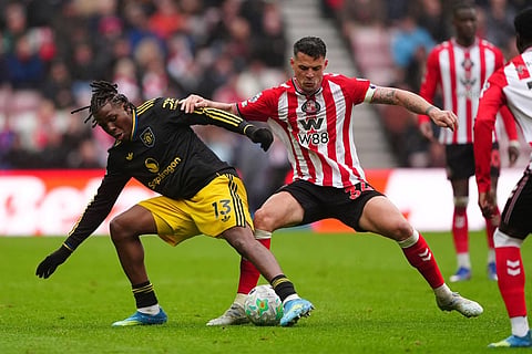 Manchester United's Patrick Dorgu, left, and Sunderland's Granit Xhaka in action during the English Premier League soccer match between Sunderland and Manchester United in Sunderland, England.