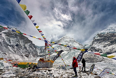 Prayers flags furl over the guides' and mountaineers' tents at the base camp of the Mount Everest, Nepal.