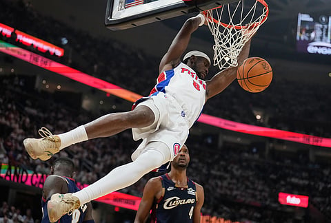 Detroit Pistons guard Caris LeVert (8) dunks in front of Cleveland Cavaliers center Evan Mobley (4) in the second half of Game 3 of a second-round NBA playoffs basketball series in Cleveland.