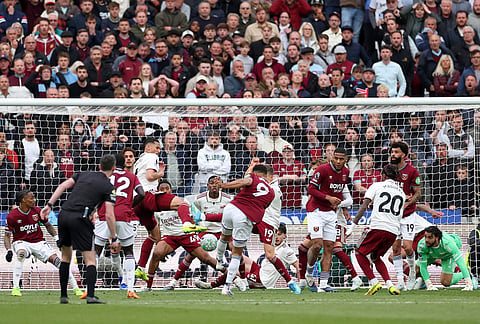 West Ham's Callum Wilson, center, scores a goal that was later disallowed following a video review during the Premier League soccer match between West Ham and Arsenal in London.