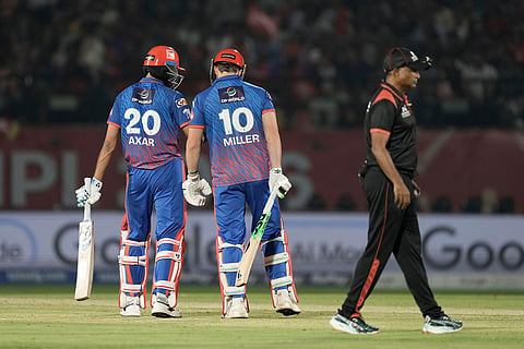 Delhi Capitals' captain Axar Patel talks to teammate David Miller as later comes out to play during the Indian Premier League cricket match between Delhi Capitals and Punjab Kings in Dharamshala, India.