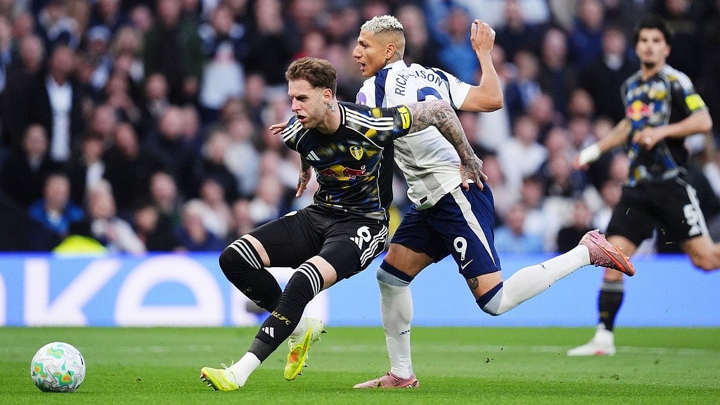 Leeds United's Joe Rodon, left, and Tottenham's Richarlison battle for the ball during the English Premier League soccer match between Totteham Hotspur and Leeds United in London, Monday, May 11, 2026 - John Walton/PA via AP