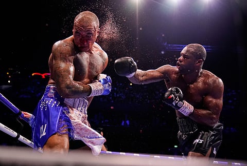 Britain's Daniel Dubois, right, lands a blow on Britain's Fabio Wardley during their WBO World Heavyweight boxing title bout in Manchester.