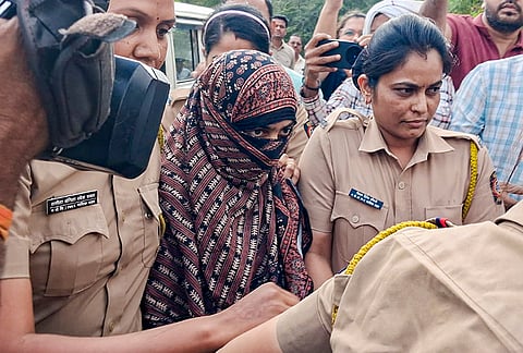 Police personnel escort Nida Khan, the prime accused in the TCS Nashik case involving alleged sexual harassment and forced religious conversions, at the Additional Sessions Court in Nashik Road. Khan was remanded to police custody till May 11. 