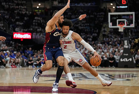 Detroit Pistons guard Cade Cunningham, right, drives against Cleveland Cavaliers guard Max Strus, left, in the second half of Game 3 of a second-round NBA playoffs basketball series in Cleveland.