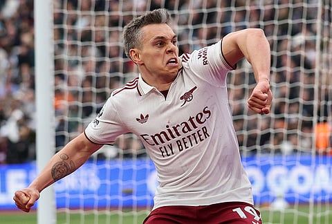 Arsenal's Leandro Trossard celebrates after scoring during the Premier League soccer match between West Ham and Arsenal in London.