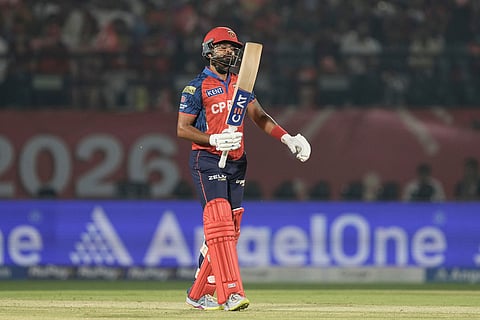 Punjab Kings' captain Shreyas Iyer looks at his bat after playing a shot during the Indian Premier League cricket match between Delhi Capitals and Punjab Kings in Dharamshala, India.
