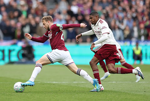 Arsenal's Cristhian Mosquera guards West Ham's Jarrod Bowen during the Premier League soccer match between West Ham and Arsenal in London.
