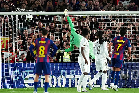 Real Madrid goalkeeper Thibaut Courtois fails to stop the opening goal from a free kick by Barcelona's Marcus Rashford during the Spanish La Liga soccer match between FC Barcelona and Real Madrid in Barcelona, Spain.