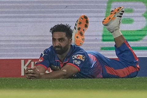 Delhi Capitals' Auqib Nabi reacts after successfully taking a catch to dismiss Punjab Kings' Prabhsimran Singh during the Indian Premier League cricket match between Delhi Capitals and Punjab Kings in Dharamshala, India.
