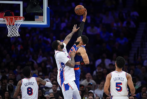 New York Knicks' Karl-Anthony Towns, right, goes up for a dunk against Philadelphia 76ers' Andre Drummond during the second half of Game 4 in a second-round NBA basketball playoffs series in Philadelphia. 