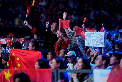 China fans watch their team beat Japan in the men's final of the World Team Table Tennis Championships in London.