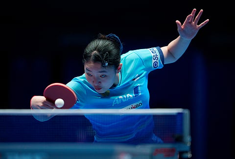 Miwa Harimoto of Japan plays a backhand on her way to beating Manyu Wang of China in their Women's Final match during the World Team Table Tennis Championships in London.