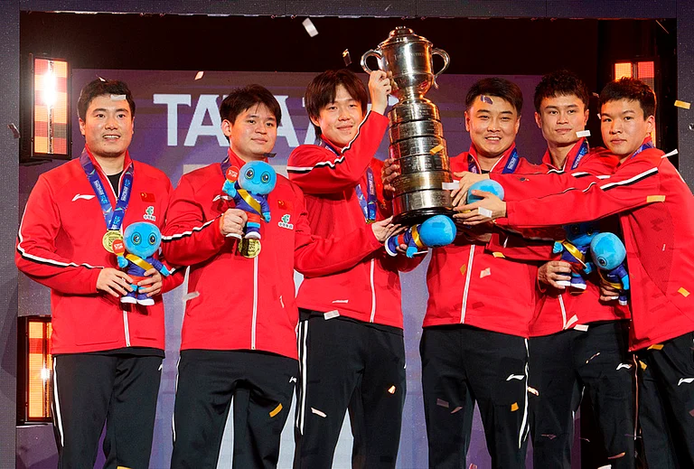 China celebrates winning the Men's Final and securing gold medal at the World Team Table Tennis Championships in London. - | Photo: AP/Jon Super