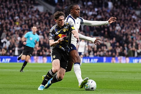 Tottenham Hotspur's Mathys Tel and Leeds United's Daniel James, left, in action during the English Premier League soccer match between Tottenham Hotspur and Leeds United in London.