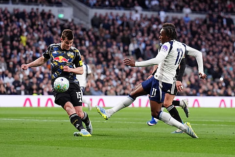 Tottenham Hotspur's Mathys Tel, right, shoots towards goal during the English Premier League soccer match between Tottenham Hotspur and Leeds United in London.