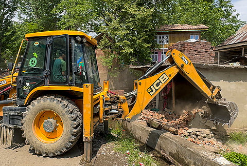 A demolition drive being carried out by Revenue Department Anantnag in coordination with Police Kulgam against a drug peddler as part of the continued crackdown against illegal narcotics trade and anti-social activities, at Drinen Qazigund, in Anantnag, Jammu and Kashmir.