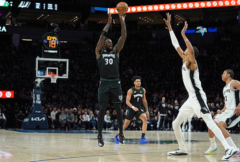 Minnesota Timberwolves forward Julius Randle (30) shoots over San Antonio Spurs forward Victor Wembanyama, second from right, during the first half of Game 4 of an NBA basketball second-round playoffs series in Minneapolis.