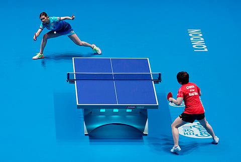 Honoka Hashimoto of Japan, left, plays Man Kuai of China in their Women's Final match during the World Team Table Tennis Championships in London.