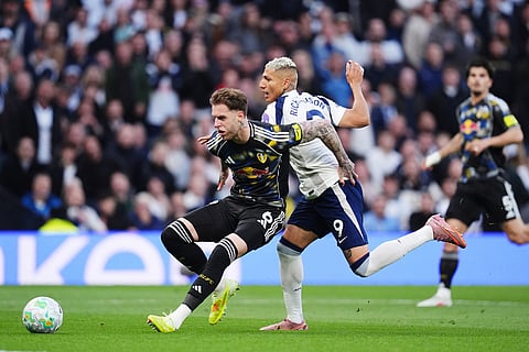 Leeds United's Joe Rodon, left, and Tottenham's Richarlison battle for the ball during the English Premier League soccer match between Totteham Hotspur and Leeds United in London.