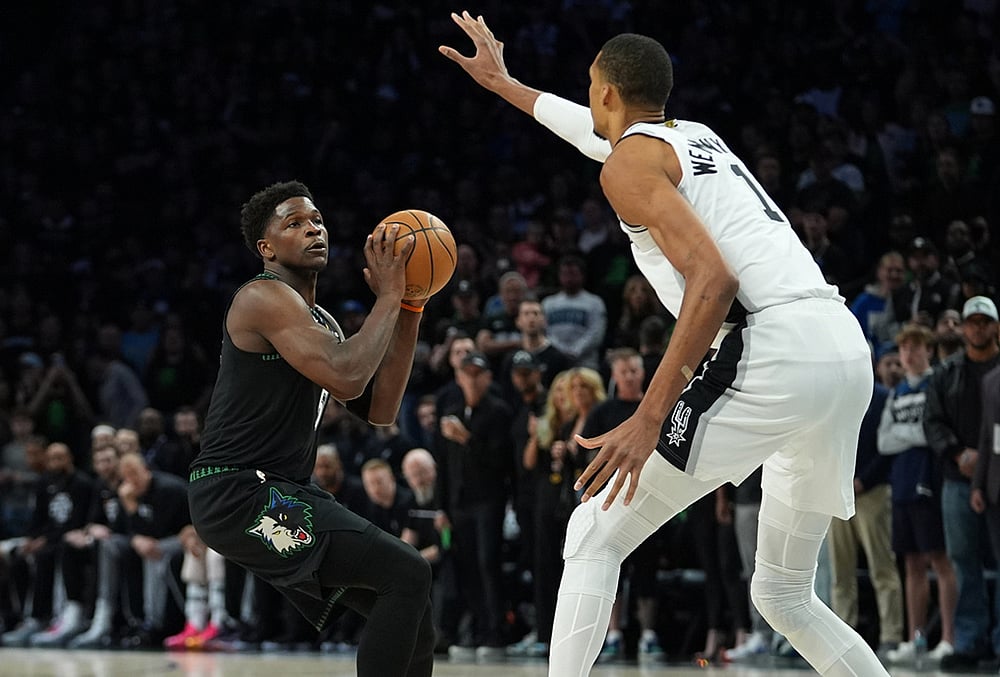 Minnesota Timberwolves guard Anthony Edwards, left, looks to shoot against San Antonio Spurs forward Victor Wembanyama (1) during the first half of Game 4 of an NBA basketball second-round playoffs series in Minneapolis. - | Photo: AP/Abbie Parr
