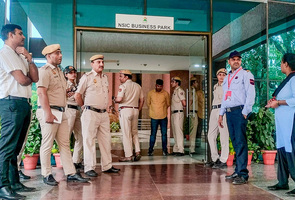 Security personnel stand guard at National Testing Agency (NTA) headquarters, over alleged paper leak concerns following the cancellation of the NEET-UG 2026 examination, in New Delhi. - | Photo: PTI