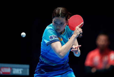 Honoka Hashimoto of Japan plays a backhand on her way to beating Man Kuai of China in their Women's Final match during the World Team Table Tennis Championships in London.