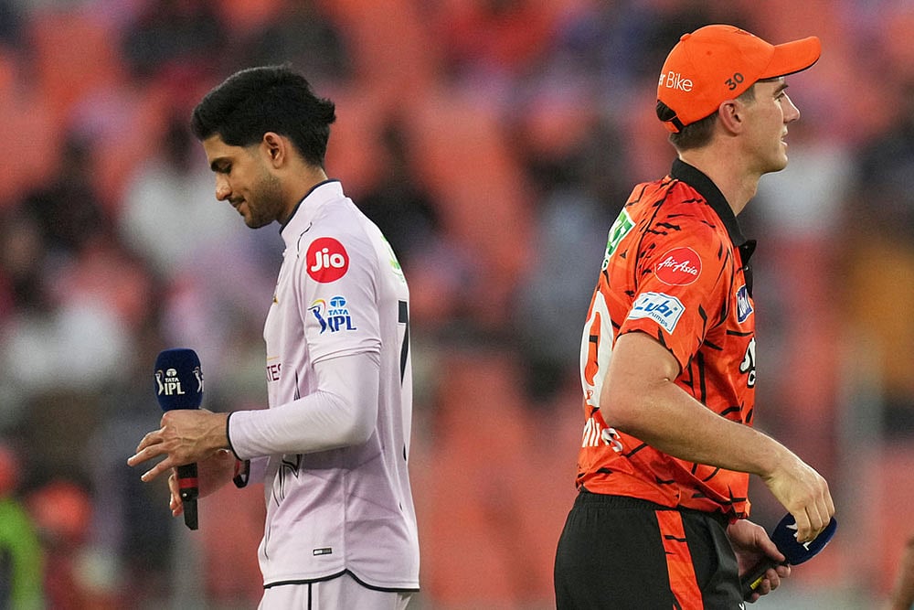 Gujarat Titans' captain Shubman Gill, left and Sunrisers Hyderabad's Pat Cummins walk after the toss of coin during the Indian Premier League cricket match between Gujarat Titans and Sunrisers Hyderabad, in Ahmedabad, India. - | Photo: AP/Ajit Solanki