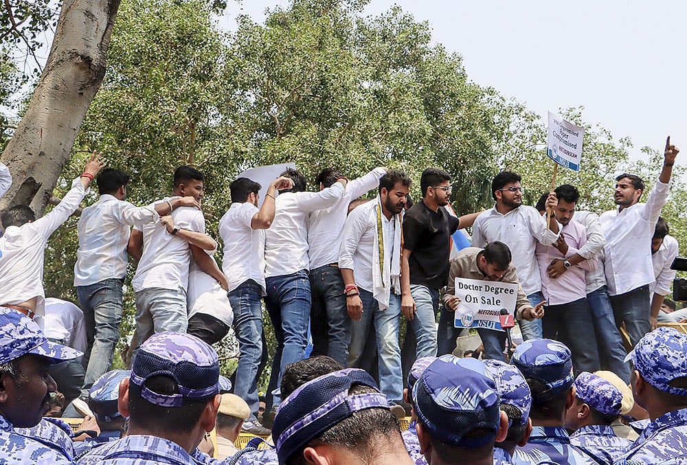 National Students’ Union of India (NSUI) members stage a demonstration against the National Testing Agency (NTA) over alleged paper leak concerns following the cancellation of the NEET-UG 2026 examination, outside Shastri Bhawan, in New Delhi. - | Photo: PTI
