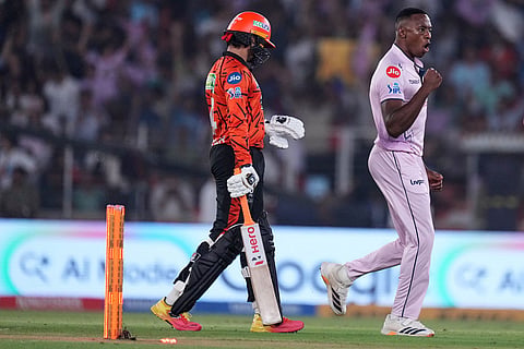 Gujarat Titans' Kagiso Rabada, centre, celebrates the wicket of Sunrisers Hyderabad's Abhishek Sharma, left, during the Indian Premier League cricket match between Gujarat Titans and Sunrisers Hyderabad, in Ahmedabad, India.