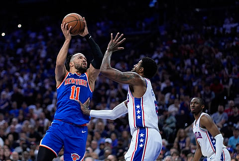 New York Knicks' Jalen Brunson, left, goes up for a shot against Philadelphia 76ers' Paul George during the first half of Game 4 in a second-round NBA basketball playoffs series in Philadelphia. 