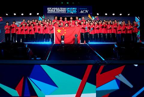 China players officials and staff celebrate winning the Men's Final and securing gold medal at the World Team Table Tennis Championships in London.