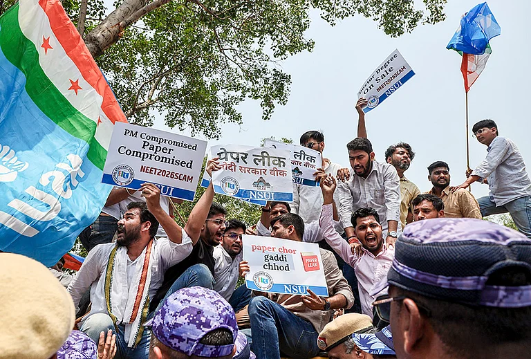 National Students’ Union of India (NSUI) members stage a demonstration against the National Testing Agency (NTA) over alleged paper leak concerns following the cancellation of the NEET-UG 2026 examination, outside Shastri Bhawan, in New Delhi. - | Photo: PTI/Tanmay Pande