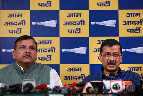 AAP National Convener Arvind Kejriwal along with party leader Sanjay Singh address a press conference, at party headquarters, in New Delhi.