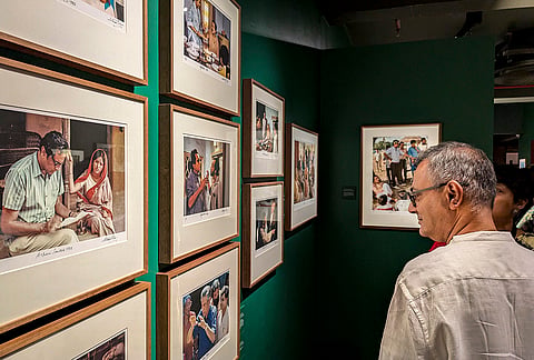 Visitors at "Faces and Facets: Satyajit Ray in Colour”, an exhibition by DAG devoted exclusively to Satyajit Ray's colour photographs by Nemai Ghosh, in New Delhi. 