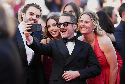 Elijah Wood, centre, takes a selfie photogragh with William Jackson, from left, Katie Jackson and Mette-Marie Kongsved at the opening ceremony and premiere of the film 'The Electric Kiss' during 79th international film festival, Cannes, southern France.