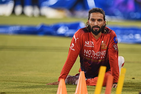 Royal Challengers Bengaluru's captain Rajat Patidar warms up before the start of the Indian Premier League cricket match between Royal Challengers Bengaluru and Kolkata Knight Riders in Raipur, India.