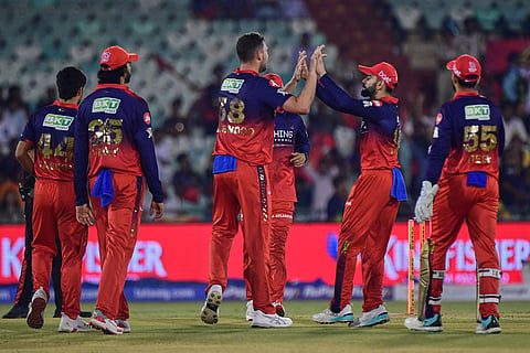 Royal Challengers Bengaluru's Josh Hazlewood, center without cap celebrates with teammates the wicket of Kolkata Knight Riders' captain Ajinkya Rahane during the Indian Premier League cricket match between Royal Challengers Bengaluru and Kolkata Knight Riders in Raipur, India.
