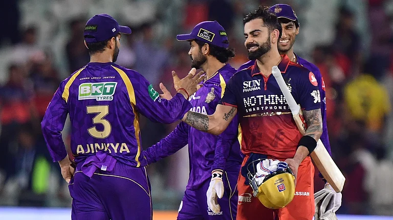 Royal Challengers Bengaluru's Virat Kohli, right, shake hands with Kolkata Knight Riders' captain Ajinkya Rahane after winning the Indian Premier League cricket match between Kolkata Knight Riders and Royal Challengers Bengaluru in Raipur, India, Wednesday, May 13, 2026 - (AP Photo/Abhijit Addya)