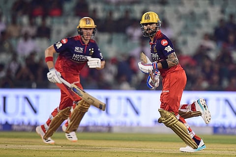 Royal Challengers Bengaluru's Virat Kohli, right, and his batting partner Jacob Bethell run between the wickets during the Indian Premier League cricket match between Royal Challengers Bengaluru and Kolkata Knight Riders in Raipur, India.