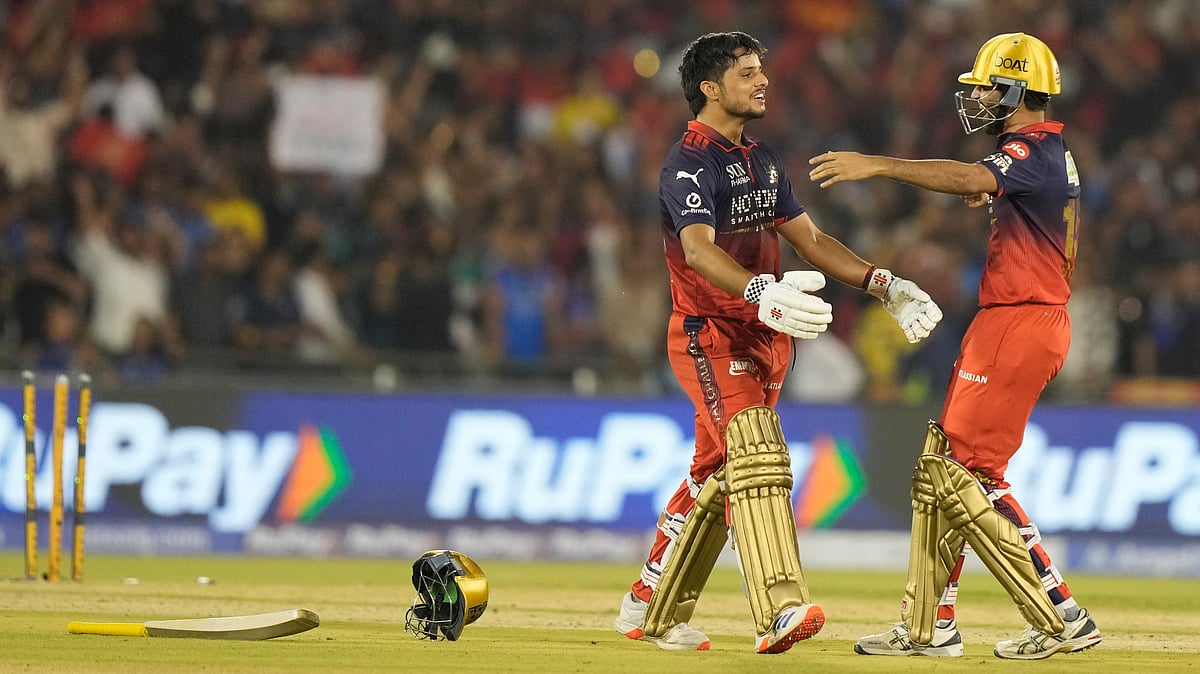 Royal Challengers Bengaluru's Rasikh Dar, left, and Bhuvneshwar Kumar celebrates after Royal Challengers Bengaluru won the match during the Indian Premier League cricket match between Royal Challengers Bengaluru and Mumbai Indians in Raipur, India, Sunday, May 10, 2026. - | Photo: AP/Mahesh Kumar A.