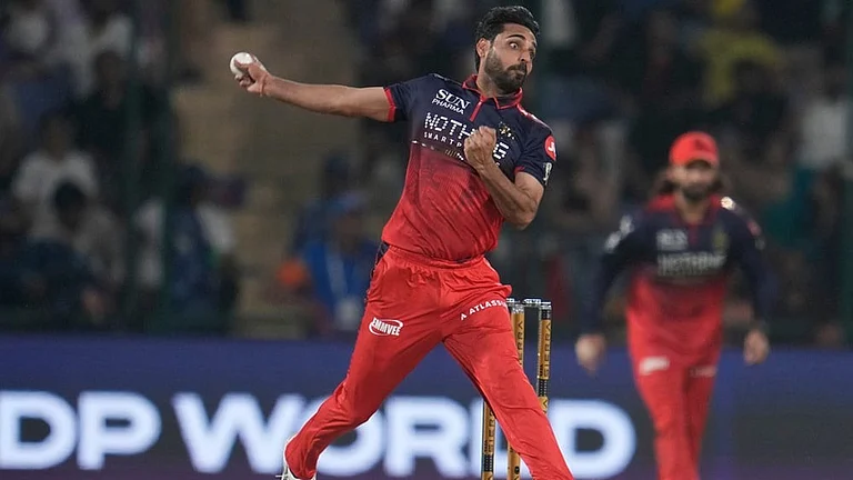 Royal Challengers Bengaluru's Bhuvneshwar Kumar bowls a delivery during the Indian Premier League cricket match between Delhi Capitals and Royal Challengers Bengaluru in Delhi. - | Photo: AP/Manish Swarup