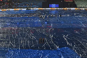 | Photo: AP/Abhijit Addya : Umpires and groundsmen inspects the field after a spell of rain before the start of Indian Premier League cricket match between Royal Challengers Bengaluru and Kolkata Knight Riders in Raipur, India.