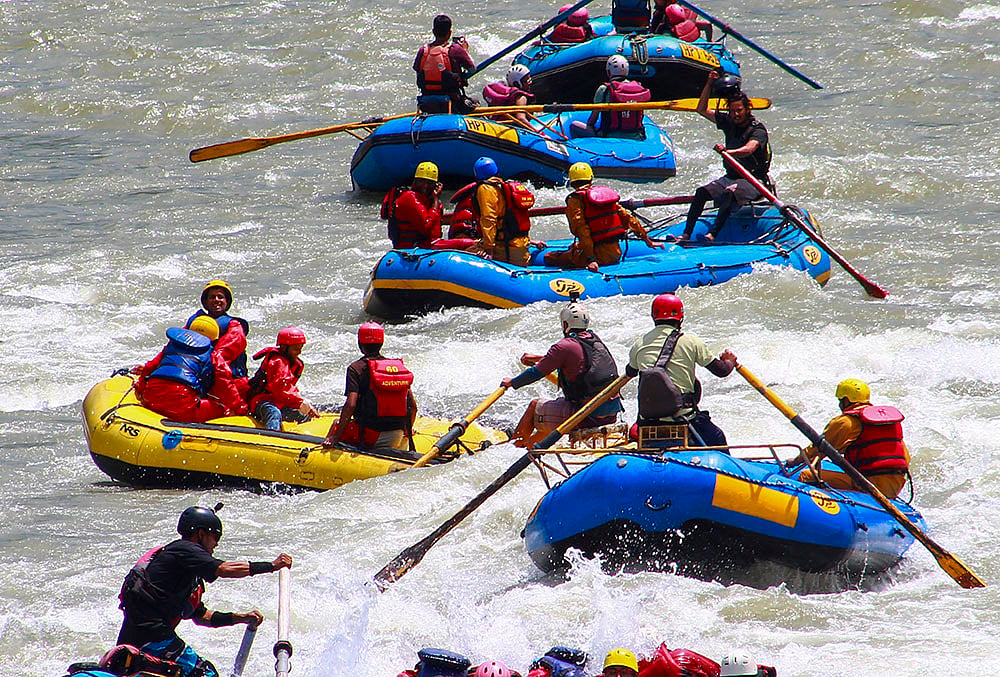 Tourists take part in river rafting