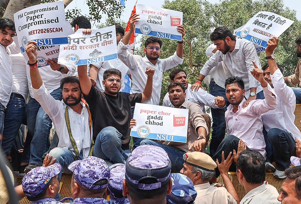 National Students' Union of India (NSUI) members stage a demonstration against the National Testing Agency (NTA) over alleged paper leak concerns following the cancellation of the NEET-UG 2026 examination, outside Shastri Bhawan, in New Delhi. - | Photo: PTI/Tanmay Pande