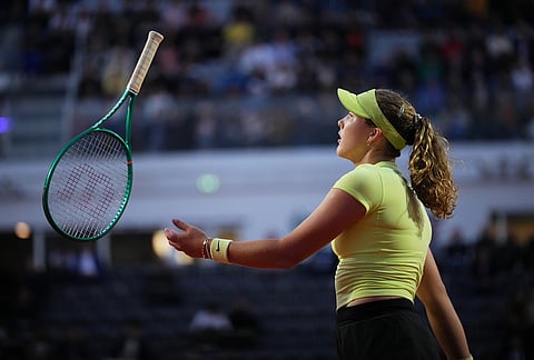 Mirra Andreeva of Russia tosses her racket after losing a point against Coco Gauff of the United States during their match at the Italian Open tennis tournament in Rome.
