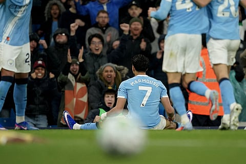 Manchester City's Omar Marmoush celebrates after scoring his side's opening goal during the English Premier League soccer match between Manchester City and Crystal Palace in Manchester, England.