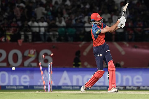 Punjab Kings' Marco Jansen is bowled out by Mumbai Indians' Shardul Thakur during the Indian Premier League cricket match between Punjab Kings and Mumbai Indians in Dharamshala, India.